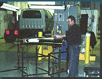 Instructor John Rademacher helping a student perform PDR on a tailgate